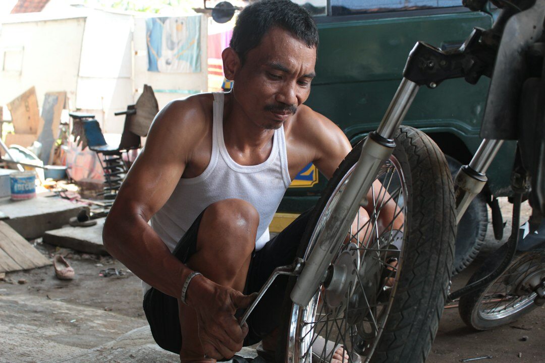 man repairing bicycle