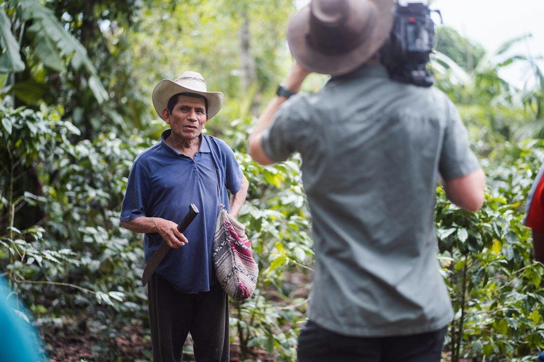 Photographer interviewing a local resident with a notebook
